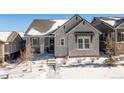 Stunning curb appeal; two-story home in winter setting at 997 Brocade Dr, Highlands Ranch, CO 80126