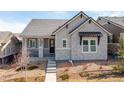 Beautiful single-story home boasts stone accents and a well-kept front yard, showcasing excellent curb appeal at 997 Brocade Dr, Highlands Ranch, CO 80126