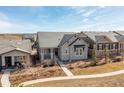 Aerial view of single-story home with charming stone accents, and beautiful landscaping at 997 Brocade Dr, Highlands Ranch, CO 80126