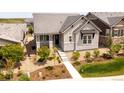 A view of the home's stone accents, tidy landscaping, and charming design at 997 Brocade Dr, Highlands Ranch, CO 80126