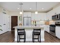Modern kitchen with sleek white cabinets, stainless steel appliances, and a spacious center island at 2729 W 28Th Ave # 302, Denver, CO 80211
