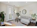 Comfortable living room boasts a large sectional sofa, stylish rug, and access to a balcony at 2729 W 28Th Ave # 302, Denver, CO 80211