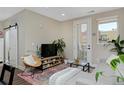 Inviting living room area with modern decor, ample natural light, and access to an outdoor balcony at 2729 W 28Th Ave # 302, Denver, CO 80211