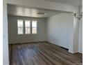 Spacious living room featuring hardwood floors and natural light streaming in through the windows at 2025 Barnwood Dr, Brighton, CO 80601