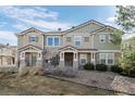 Attractive townhome exterior featuring stone accents and well-maintained landscaping at 9771 Mayfair St # F, Englewood, CO 80112