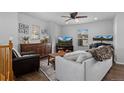 Cozy living room with comfortable seating, ceiling fan, and natural light at 9771 Mayfair St # F, Englewood, CO 80112