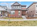 Charming two-story home featuring a brick facade and covered front porch at 82 Oneida St, Denver, CO 80230