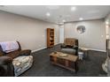 Comfortable living room with neutral walls, patterned carpet, and an inviting space for relaxation and entertainment at 8240 Clayton Ct, Denver, CO 80229