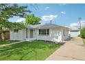 Well-maintained exterior with a detached garage and a long driveway for multiple cars at 169 Yates St, Denver, CO 80219