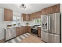 Modern kitchen featuring stainless steel appliances, stylish cabinetry, and a bright window at 169 Yates St, Denver, CO 80219