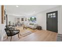 Bright living room with hardwood floors, a large window, and stylish furniture at 169 Yates St, Denver, CO 80219