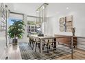 Bright dining room with modern chandelier, large windows, and stylish decor, perfect for entertaining at 512 Cook St, Denver, CO 80206