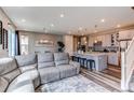 Bright open floor plan with kitchen island, stainless appliances, and modern finishes at 21302 E Radcliff Pl, Aurora, CO 80015