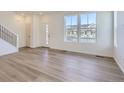 Bright living room with hardwood floors, large windows, and plenty of natural light at 728 N Bently St, Watkins, CO 80137