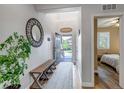 Inviting foyer featuring a decorative mirror, bench seating, and a view into the home at 21658 E Tallkid Ave, Parker, CO 80138