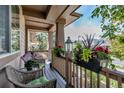 Charming covered front porch with wicker furniture, potted plants, and decorative accents for relaxation at 21658 E Tallkid Ave, Parker, CO 80138