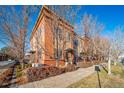 View of the home's exterior, showcasing its brick facade and landscaping at 7777 E 1St Pl # 110, Denver, CO 80230