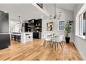 Bright open-concept layout with hardwood floors, a modern kitchen, and a stylish dining area at 2827 Bellaire St, Denver, CO 80207