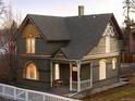 Beautiful two-story home featuring unique architectural details and a cozy front porch at 1433 Olive St, Denver, CO 80220