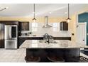 Modern kitchen with stainless steel appliances, granite countertops, and a functional center island at 1433 Olive St, Denver, CO 80220