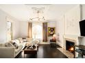 Bright living room with hardwood floors, fireplace, and large windows for plenty of natural light at 1433 Olive St, Denver, CO 80220