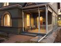 Inviting front porch with comfortable seating, brick accents, and great curb appeal at 1433 Olive St, Denver, CO 80220