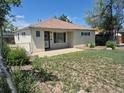Charming single-story home with quaint front yard with a concrete porch and a fenced yard at 1303 Havana St, Aurora, CO 80010