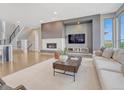 Cozy living room with a modern fireplace, neutral decor, and ample natural light at 9395 Night Star Pl, Lone Tree, CO 80124