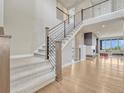 Elegant staircase with modern railings, leading to a bright, open-concept living space at 9395 Night Star Pl, Lone Tree, CO 80124