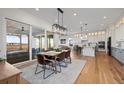 Open-concept dining room with access to the kitchen and large sliding doors leading to the backyard at 751 Green Mountain Dr, Erie, CO 80516