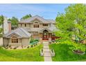 Attractive home with a gray tile roof, lush lawn and tasteful landscaping at 2252 S Queen St, Lakewood, CO 80227