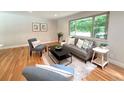 Comfortable living room with plush seating, soft rug, and a large window view at 8426 W Woodard Dr, Lakewood, CO 80227