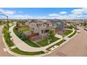 Aerial view of a two-story home with solar panels and a fenced backyard in a suburban neighborhood at 13205 E 109Th Ave, Commerce City, CO 80022