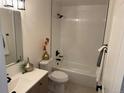 Bathroom features a tub with modern tile, a vanity with black hardware, and decorative accents at 3866 S King St, Denver, CO 80236