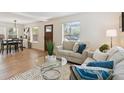 Inviting living room boasts hardwood floors, neutral-toned furniture, and plenty of natural light at 3866 S King St, Denver, CO 80236
