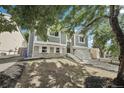 Lovely two-story home with an attached two-car garage and manicured lawn, showcasing suburban charm at 19954 E Dartmouth Ave, Aurora, CO 80013