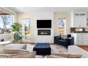 Cozy living room featuring a modern fireplace, large windows, and stylish furniture at 2600 S Sherman St, Denver, CO 80210