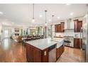 Spacious open kitchen with a large island, stainless steel appliances, and hardwood floors, flowing into the dining area at 3357 N Akron Ct, Denver, CO 80238