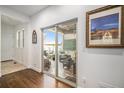 Inviting covered patio with comfortable wicker furniture, accessible through sliding glass doors at 3357 N Akron Ct, Denver, CO 80238