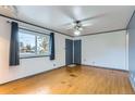 Bright living room featuring hardwood floors, fresh paint, and a ceiling fan at 8511 Essex Dr, Denver, CO 80229