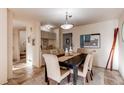 Elegant dining room features a large table, plush chairs, and access to a bar area at 1530 S Quebec Way # 29, Denver, CO 80231