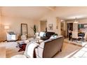 Open-concept living area with hardwood floors, comfortable seating, and ample natural light at 1530 S Quebec Way # 29, Denver, CO 80231