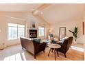 Spacious living room featuring neutral tones, vaulted ceilings, and comfortable seating arrangements at 1530 S Quebec Way # 29, Denver, CO 80231