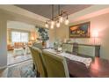 Dining room with decorative lighting, wooden table with seating for six, and a view into the living room at 919 Taylor Ln, Erie, CO 80516