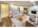 Virtually staged living room featuring a fireplace and wood-look flooring at 7995 E Mississippi Ave # F11, Denver, CO 80247