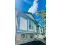 Two-story home with light-blue trim and brick on a sunny day at 19954 E Dartmouth Ave, Aurora, CO 80013