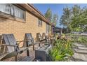 Charming patio with brick pavers, mature landscaping and comfortable seating; perfect for outdoor relaxation at 3224 Troy St, Aurora, CO 80011