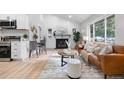 Bright living room featuring a leather sofa and stylish decor at 30 S Yates St, Denver, CO 80219