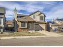 Two-story home with attached garage and nicely landscaped yard at 9125 Bell Flower Way, Highlands Ranch, CO 80126