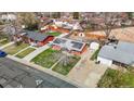 An aerial view showcases a red brick home with a solar panel roof, nestled in a residential area at 3341 W 94Th Ave, Westminster, CO 80031